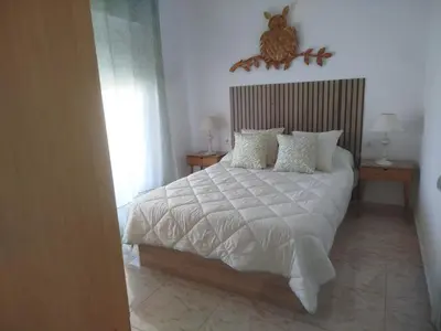 a bedroom with a large white bed with pillows at Estudio cerca de la playa in Valencia