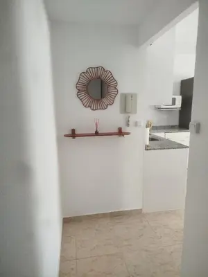 a white room with a mirror on a wall at Estudio cerca de la playa in Valencia