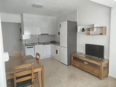 a kitchen with a table and a television in it at Estudio cerca de la playa in Valencia