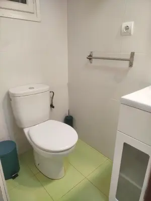 a white bathroom with a toilet and a sink at Estudio cerca de la playa in Valencia