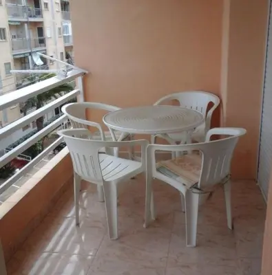a white table and chairs on a balcony at Estudio cerca de la playa in Valencia