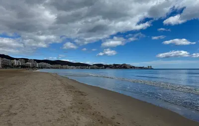 a view of the beach with buildings in the background at La Turia Soleada in Cullera