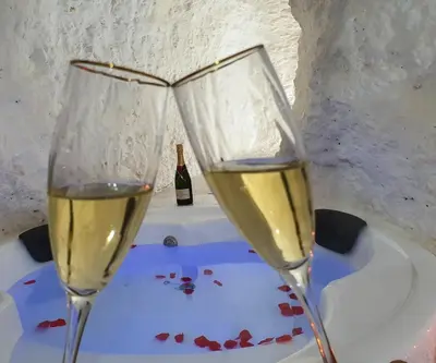 two glasses of white wine sitting on a table at casa cueva a 15 minutos del centro de Valencia in Paterna