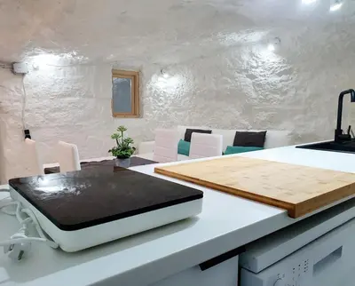 a kitchen with a cutting board on a counter at casa cueva a 15 minutos del centro de Valencia in Paterna