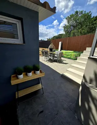 a patio with chairs and a table with potted plants at Casa Rural El Bressol in Barraca de Aguas Vivas