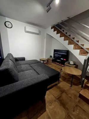 a living room with a couch and a tv at Casa Rural El Bressol in Barraca de Aguas Vivas