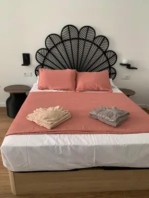 a bed with two towels on top of it at Central Park Flats by VIVOGC in Valencia