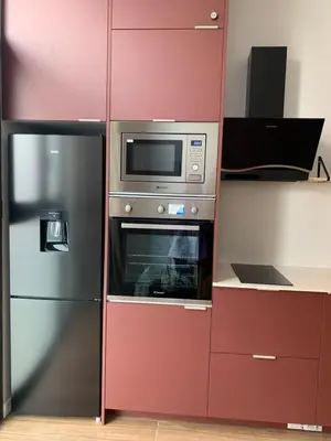 a red cabinet with a microwave and a refrigerator at Central Park Flats by VIVOGC in Valencia
