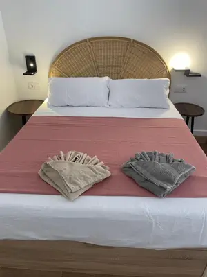 a bedroom with a bed with two towels on it at Central Park Flats by VIVOGC in Valencia