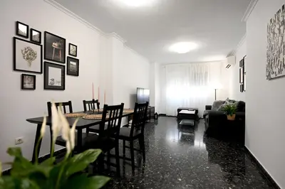 a dining room and living room with a table and chairs at EMMA Apartment in Puerto de Sagunto