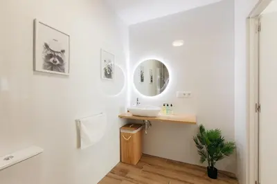 a bathroom with a sink and a mirror at Stylish Studio with Easy Access to Valencias Best in Valencia