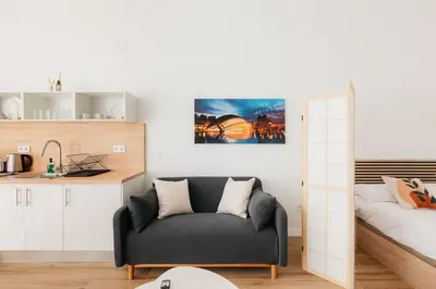 a living room with a couch and a bed at Stylish Studio with Easy Access to Valencias Best in Valencia