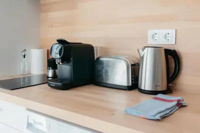 a kitchen counter with a coffee maker and a toaster at Stylish Studio with Easy Access to Valencias Best in Valencia