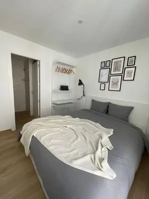 a white bedroom with a large bed in it at Cute little apartment in Godella