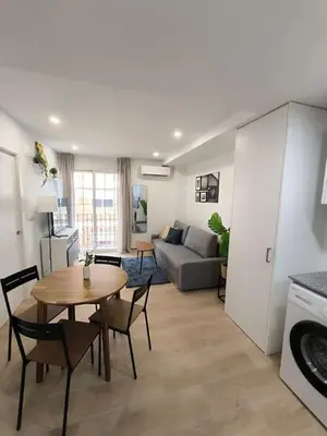 a living room with a table and a couch at Cute little apartment in Godella