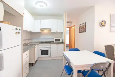 a bedroom with a bed and a wooden cabinet at Global Vacacional, Ático con barbacoa y gran terraza in Canet de Berenguer