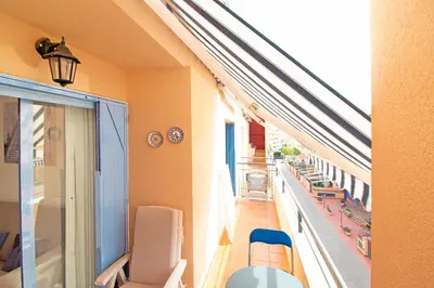 a living room with a couch and a table and chairs at Global Vacacional, Ático con barbacoa y gran terraza in Canet de Berenguer