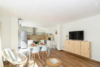 a kitchen and living room with a table and chairs at GuestReady - Your Sunny Valencia Basecamp in Valencia