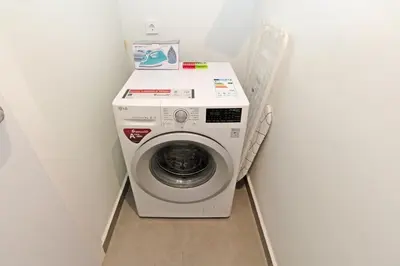 a washer and dryer in a small room at GuestReady - Your Sunny Valencia Basecamp in Valencia