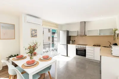 a kitchen and dining room with a table and chairs at GuestReady - Your Sunny Valencia Basecamp in Valencia