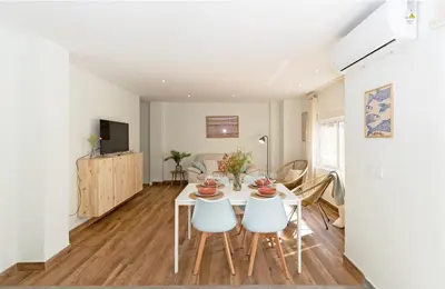 a dining room and living room with a table and chairs at GuestReady - Your Sunny Valencia Basecamp in Valencia