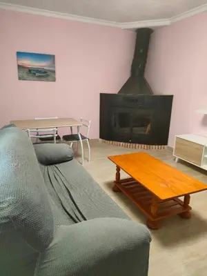 a living room with a couch and a fireplace at Brisas del Lago in Navarrés