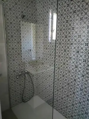 a bathroom with a shower with a glass door at Brisas del Lago in Navarrés
