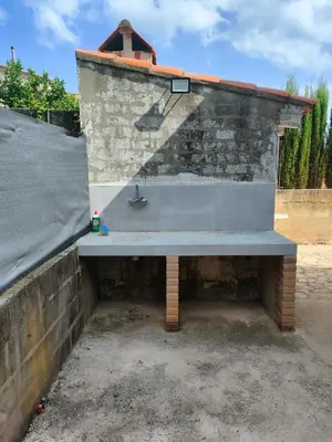 a bench sitting next to a brick wall at Brisas del Lago in Navarrés