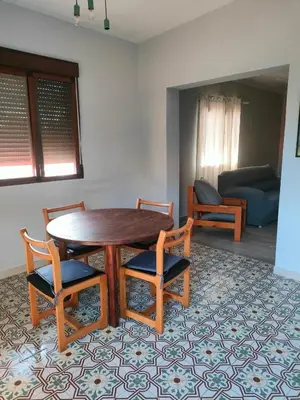 a room with a table and chairs and a couch at Brisas del Lago in Navarrés