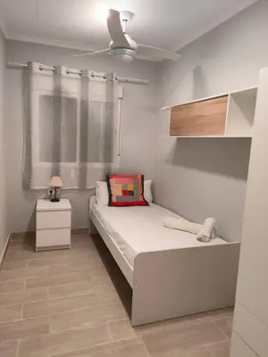a small bedroom with a bed and a window at Brisas del Lago in Navarrés