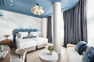 a bedroom with a bed and a living room at One Shot Puerta Ruzafa in Valencia