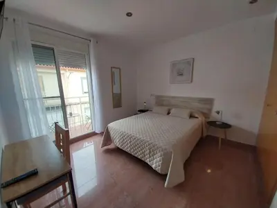 a bedroom with a bed and a large window at Casa Santa Úrsula in Casinos