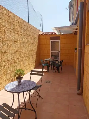 a patio with tables and chairs and a wall at Casa Santa Úrsula in Casinos
