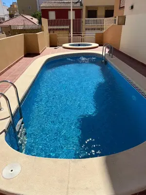 a large blue swimming pool in the middle of a building at Apartment with the pool in Moncófar