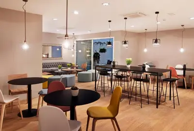 a restaurant with tables and chairs in a room at One Shot Colón in Valencia