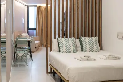 a bedroom with a bed and a table in a room at VLC HOST - Palleter in Valencia