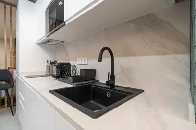 a kitchen with a black sink and a counter at VLC HOST - Palleter in Valencia
