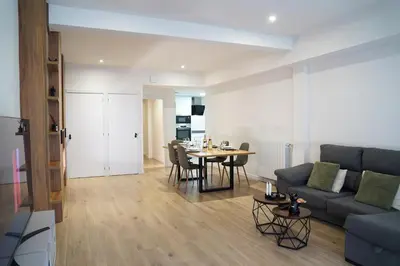 a living room with a couch and a table at Casa Dolce Casa - Elegant 3BR Apartment Near Metro & Beach,Valencia in Valencia