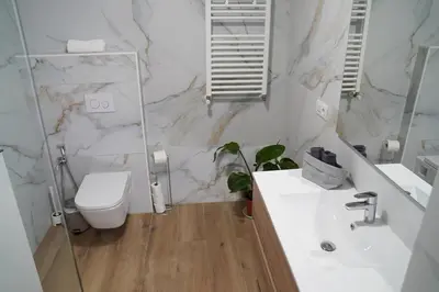 a white bathroom with a toilet and a sink at Casa Dolce Casa - Elegant 3BR Apartment Near Metro & Beach,Valencia in Valencia