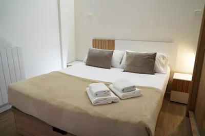 a bedroom with a bed with towels on it at Casa Dolce Casa - Elegant 3BR Apartment Near Metro & Beach,Valencia in Valencia
