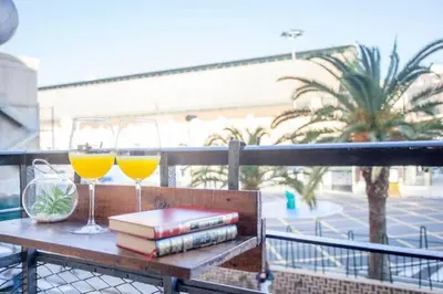 two glasses of wine and books on a table on a balcony at new apartment 4 pax front central station wifi in Valencia
