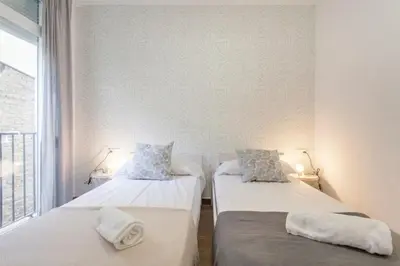 two beds in a room with a window at new apartment 4 pax front central station wifi in Valencia