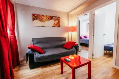 a living room with a couch and a table at Queen Apt, 2min to Beach, Terrace, 3BD, 6PAX in Valencia