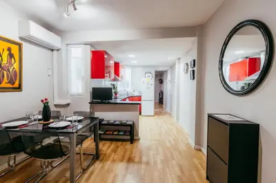 a living room with a table and a mirror at Queen Apt, 2min to Beach, Terrace, 3BD, 6PAX in Valencia