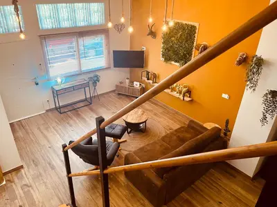 a living room with a couch and a table at Dúplex tipo loft de estilo selvático y safari, con encanto y a pasos del mar in Valencia