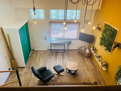 an overhead view of a living room with a table at Dúplex tipo loft de estilo selvático y safari, con encanto y a pasos del mar in Valencia