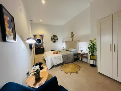 a bedroom with a bed and a table in a room at Hotel con entrada independiente a pocos pasos de la Ciudad de las Artes y las Ciencias y el Oceanogràfic A solo 1 minuto caminando del Jardín del Turia in Valencia
