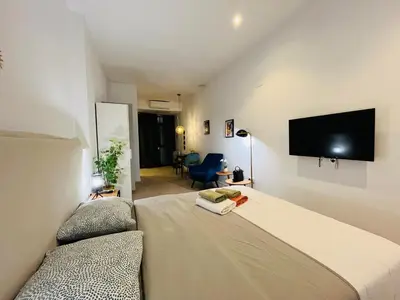 a bedroom with a bed and a flat screen tv at Hotel con entrada independiente a pocos pasos de la Ciudad de las Artes y las Ciencias y el Oceanogràfic A solo 1 minuto caminando del Jardín del Turia in Valencia