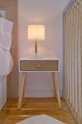 a table with a lamp on it next to a bed at Romantic Suite Roig Arena N10 Virkin Suites in Valencia