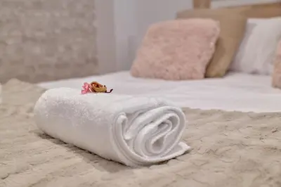 a white towel on a bed with a toy on it at Romantic Suite Roig Arena N10 Virkin Suites in Valencia